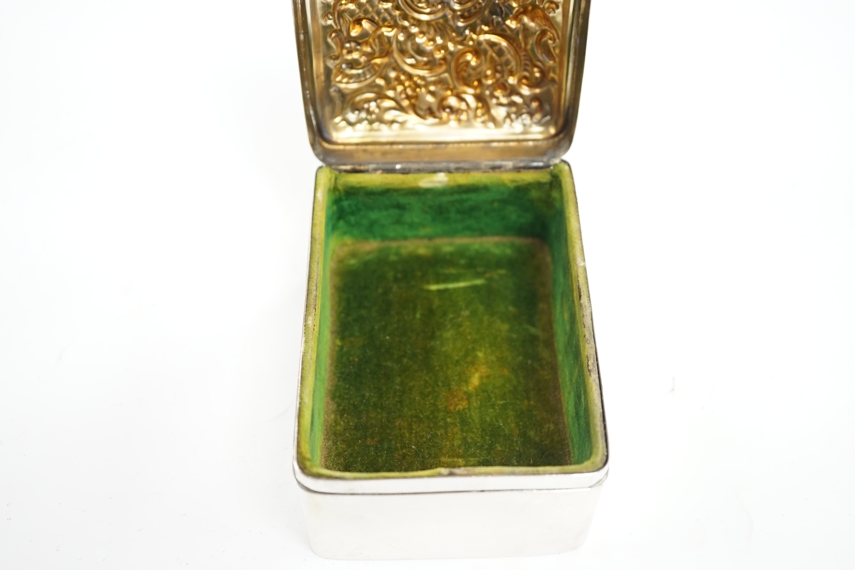 An Edwardian silver trinket box, with repousse hinged cover, William Comyns, London, 1907, 11cm. Condition - poor to fair